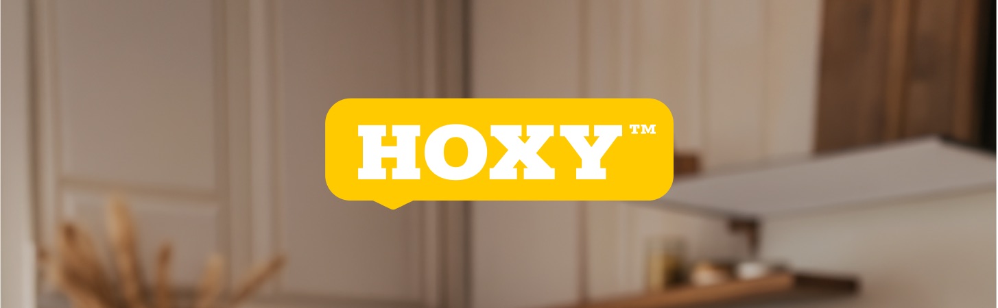 HOXY logo banner module on a blurred kitchen photograph